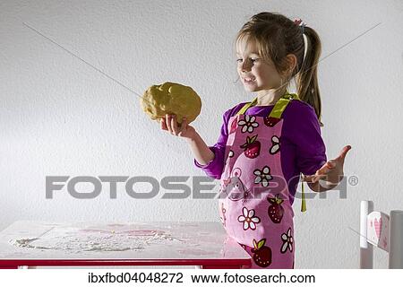 "Girl, 3 years, baking, holding a lump of dough in her hand" View Large Photo Image Stock Image - "Girl, 3 years, baking, holding a lump of dough in her hand". Fotosearch