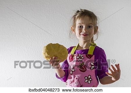 "Girl, 3 years, baking, holding a lump of dough in her hand" View Large Photo Image Stock Image - "Girl, 3 years, baking, holding a lump of dough in her hand". Fotosearch