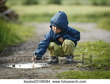 "Girl, 4, playing in a puddle in the rain, Crailsheim, Hohenlohe, Baden-Wurttemberg, Germany, Europe" View Large Photo Image Picture - "Girl, 4, playing in a puddle in the rain, Crailsheim, Hohenlohe, Baden-Wurttemberg, Germany, Europe". Fotosearch