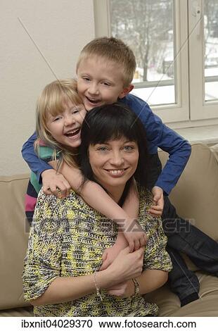 "Girl, 5 years, boy, 7 years, with their mother, 35 years, on a sofa" View Large Photo Image Stock Image - "Girl, 5 years, boy, 7 years, with their mother, 35 years, on a sofa". Fotosearch