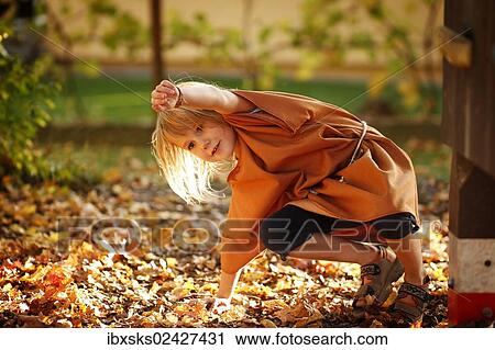 "Girl, 7 years, playing on a playground with autumn foliage" View Large Photo Image Stock Image - "Girl, 7 years, playing on a playground with autumn foliage". Fotosearch