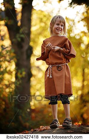 "Girl, 7 years, playing outside with autumn leaves, dressed up for theatre" View Large Photo Image Stock Photo - "Girl, 7 years, playing outside with autumn leaves, dressed up for theatre". Fotosearch