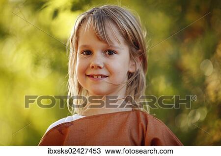 "Girl, 7 years, portrait, outdoors, autumn light" View Large Photo Image Stock Image - "Girl, 7 years, portrait, outdoors, autumn light". Fotosearch
