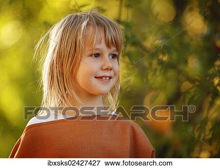"Girl, 7 years, portrait, outdoors, autumn light" View Large Photo Image Stock Photo - "Girl, 7 years, portrait, outdoors, autumn light". Fotosearch