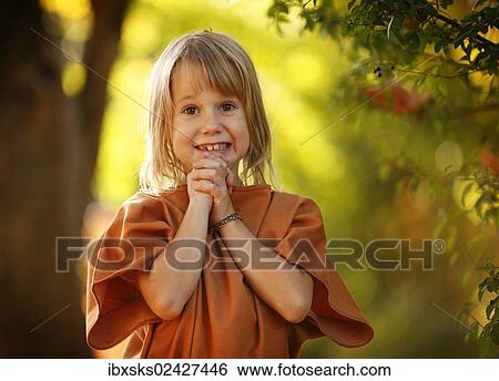 Stock Photograph - "Girl, 7 years, portrait, outdoors, autumn light". Fotosearch