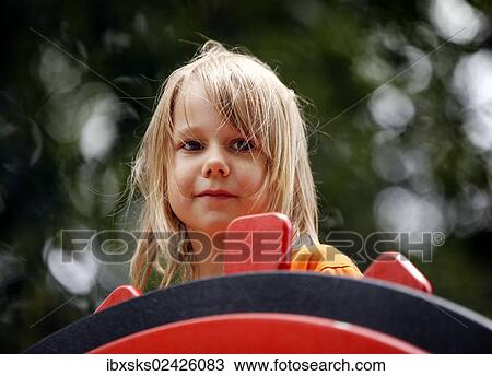 "Girl, 7 years, steering a toy ship on a playground" View Large Photo Image Stock Image - "Girl, 7 years, steering a toy ship on a playground". Fotosearch