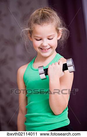 "Girl, 8, exercising with a small dumbbell" View Large Photo Image Stock Image - "Girl, 8, exercising with a small dumbbell". Fotosearch