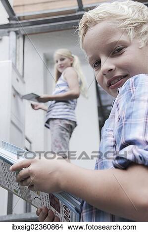 Girl and boy delivering advertising View Large Photo Image Picture - Girl and boy delivering advertising. Fotosearch