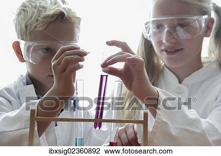 Girl and boy playfully doing chemistry experiments View Large Photo Image Stock Image - Girl and boy playfully doing chemistry experiments. Fotosearch