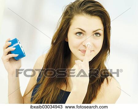 Girl applying cream to her nose View Large Photo Image Stock Image - Girl applying cream to her nose. Fotosearch