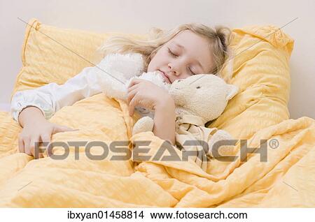 Picture - Girl asleep in bed. Fotosearch