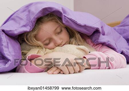 Girl asleep under bedspread View Large Photo Image Stock Photo - Girl asleep under bedspread. Fotosearch