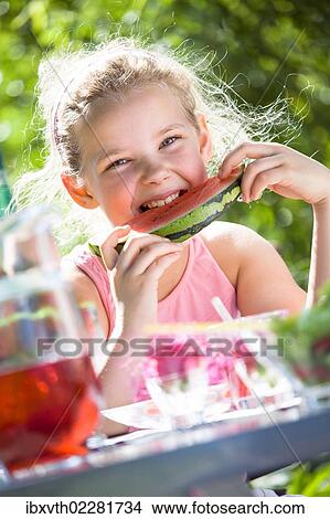 Picture - Girl at a garden table. Fotosearch