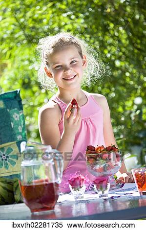 Girl at a garden table View Large Photo Image Stock Photography - Girl at a garden table. Fotosearch