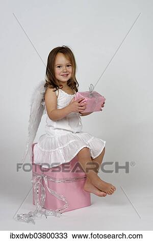 "Girl dressed as angel, with Christmas gifts" View Large Photo Image Stock Image - "Girl dressed as angel, with Christmas gifts". Fotosearch