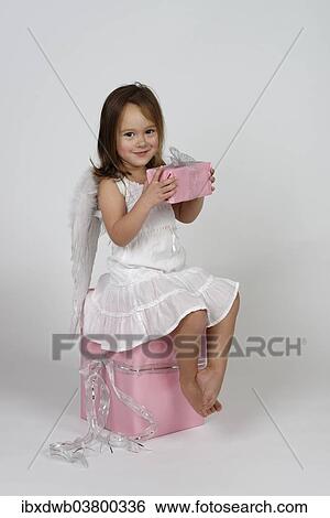 "Girl dressed as angel, with Christmas gifts" View Large Photo Image Stock Photograph - "Girl dressed as angel, with Christmas gifts". Fotosearch