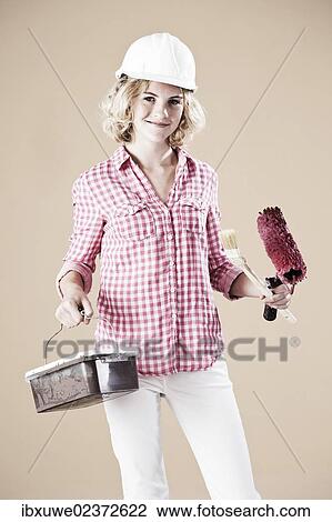 Girl dressed like a painter wearing a hard hat View Large Photo Image Stock Image - Girl dressed like a painter wearing a hard hat. Fotosearch