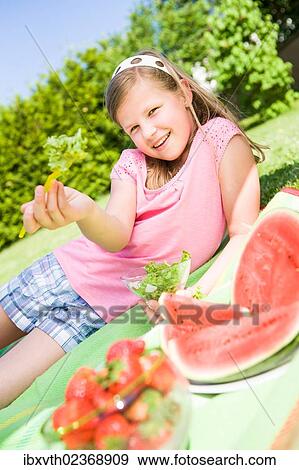 "Girl eating salad, watermelon, a bowl of strawberries, in a garden" View Large Photo Image Stock Photo - "Girl eating salad, watermelon, a bowl of strawberries, in a garden". Fotosearch