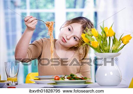 Stock Photography - Girl eating spaghetti. Fotosearch