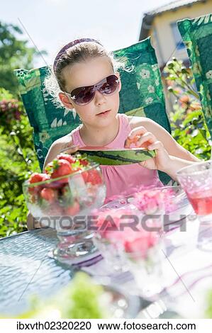 Girl eating watermelon in the garden View Large Photo Image Stock Image - Girl eating watermelon in the garden. Fotosearch