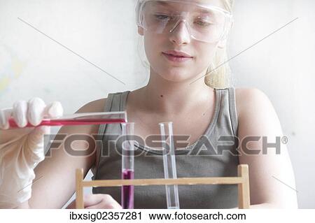 "Girl experimenting with a chemistry set, pouring a chemical solution into a test tube" View Large Photo Image Stock Image - "Girl experimenting with a chemistry set, pouring a chemical solution into a test tube". Fotosearch