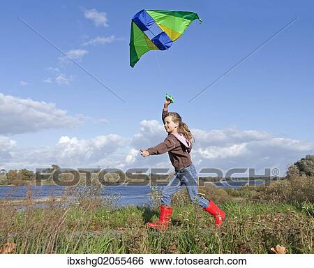 "Girl flying a kite, kiteflying, Hitzacker, Lower Saxony, Germany, Europe" View Large Photo Image Stock Photograph - "Girl flying a kite, kiteflying, Hitzacker, Lower Saxony, Germany, Europe". Fotosearch