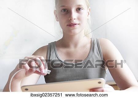Girl holding a digital tablet and a USB connector View Large Photo Image Stock Image - Girl holding a digital tablet and a USB connector. Fotosearch