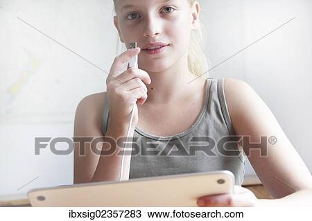 Girl holding a digital tablet and a USB connector View Large Photo Image Stock Image - Girl holding a digital tablet and a USB connector. Fotosearch