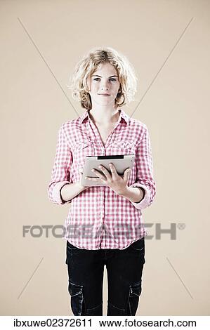 Stock Image - Girl holding a digital tablet in her hands. Fotosearch