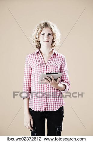 Stock Image - Girl holding a digital tablet in her hand. Fotosearch