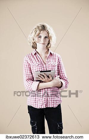 Girl holding a digital tablet in her hand View Large Photo Image Stock Image - Girl holding a digital tablet in her hand. Fotosearch