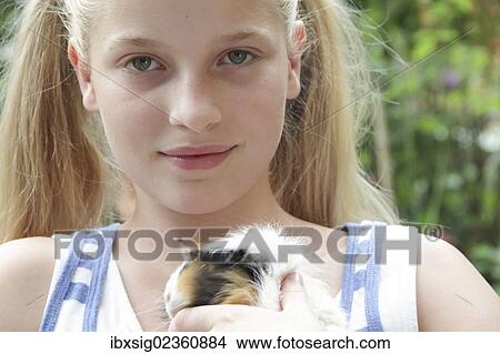 Picture - Girl holding a guinea pig. Fotosearch