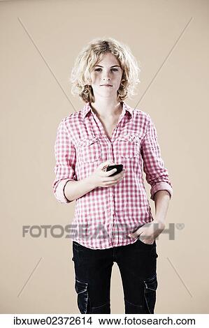 Girl holding a smartphone in her hand View Large Photo Image Picture - Girl holding a smartphone in her hand. Fotosearch