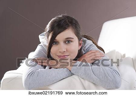 Girl lying on a couch View Large Photo Image Stock Photo - Girl lying on a couch. Fotosearch