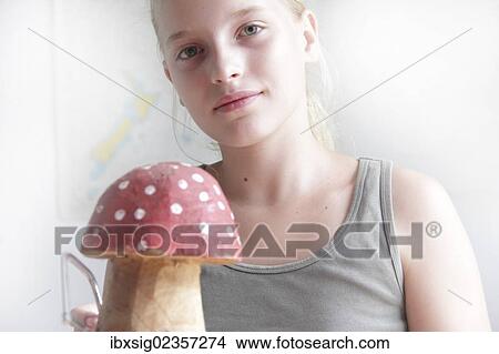 Girl making a fly agaric mushroom with the saw from a piece of wood View Large Photo Image Picture - Girl making a fly agaric mushroom with the saw from a piece of wood. Fotosearch