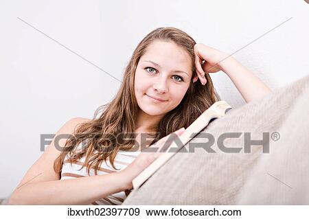 "Girl on a sofa, reading a book" View Large Photo Image Stock Photo - "Girl on a sofa, reading a book". Fotosearch