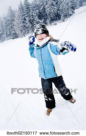 Girl playing in the snow View Large Photo Image Stock Photo - Girl playing in the snow. Fotosearch