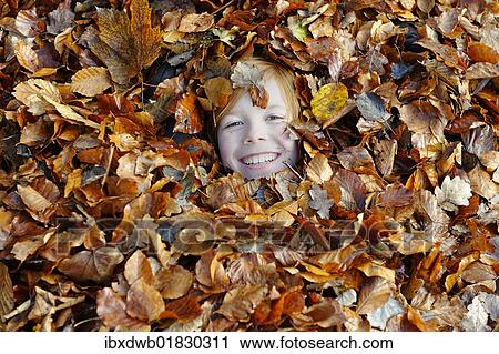 Girl playing with leaves in autumn View Large Photo Image Stock Image - Girl playing with leaves in autumn. Fotosearch