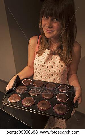 Girl presenting her homemade Oreo brownie cupcakes View Large Photo Image Stock Photo - Girl presenting her homemade Oreo brownie cupcakes. Fotosearch