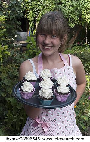 Girl presenting her homemade Oreo brownie cupcakes View Large Photo Image Stock Photography - Girl presenting her homemade Oreo brownie cupcakes. Fotosearch