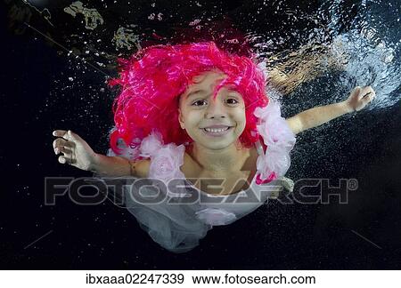 Girl presenting underwater fashion in pool View Large Photo Image Stock Photo - Girl presenting underwater fashion in pool. Fotosearch