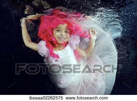 Girl presenting underwater fashion in pool View Large Photo Image Stock Photography - Girl presenting underwater fashion in pool. Fotosearch