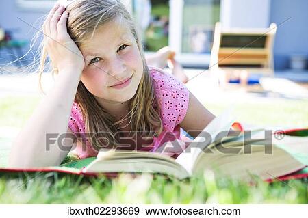Girl reading in the garden View Large Photo Image Stock Photo - Girl reading in the garden. Fotosearch