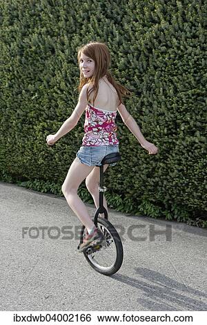 Girl riding the unicycle View Large Photo Image Stock Photograph - Girl riding the unicycle. Fotosearch