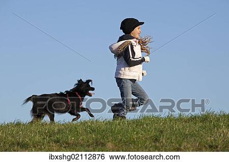 Stock Photograph - Girl running with a dog. Fotosearch