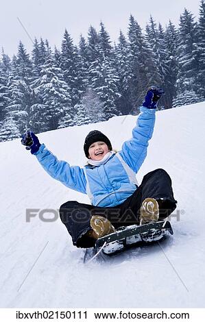 Girl sledding in the snow View Large Photo Image Stock Image - Girl sledding in the snow. Fotosearch