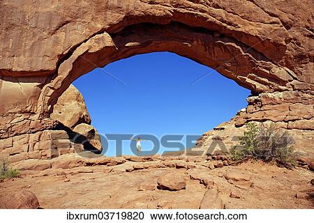 "Girl standing in North Window Arch, a stone arch of red sandstone formed by erosion, Arches-Nationalpark, near Moab, Utah, United States, North America" View Large Photo Image Stock Image - "Girl standing in North Window Arch, a stone arch of red sandstone formed by erosion, Arches-Nationalpark, near Moab, Utah, United States, North America". Fotosearch