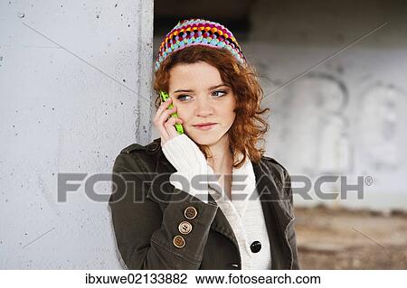 Stock Image - Girl talking on a mobile phone. Fotosearch