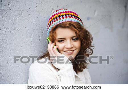 Girl talking on a mobile phone View Large Photo Image Stock Photograph - Girl talking on a mobile phone. Fotosearch