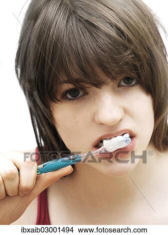 Picture - "Girl, teenager, brushing her teeth". Fotosearch